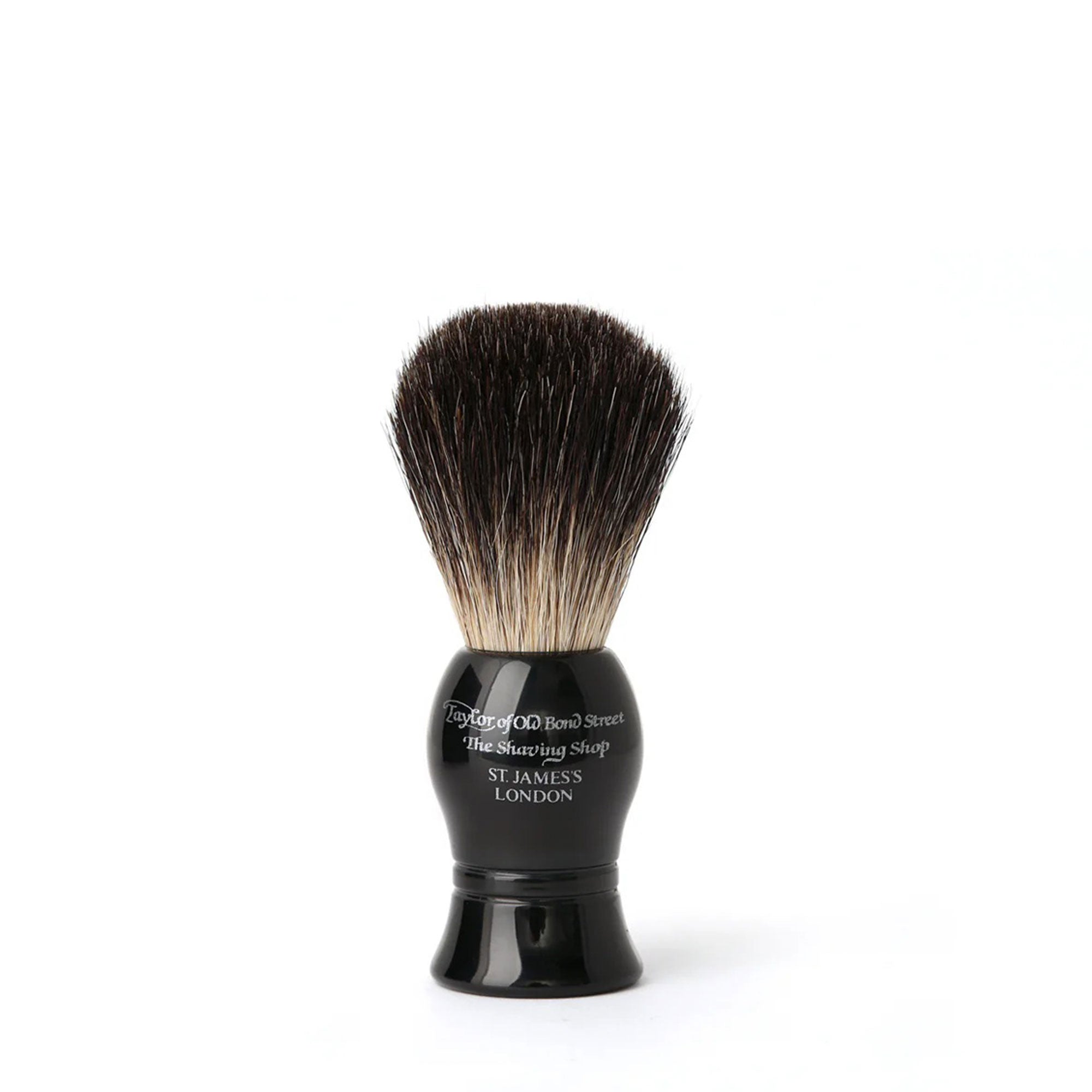 Shaving brush with black handle and bristles on a white background